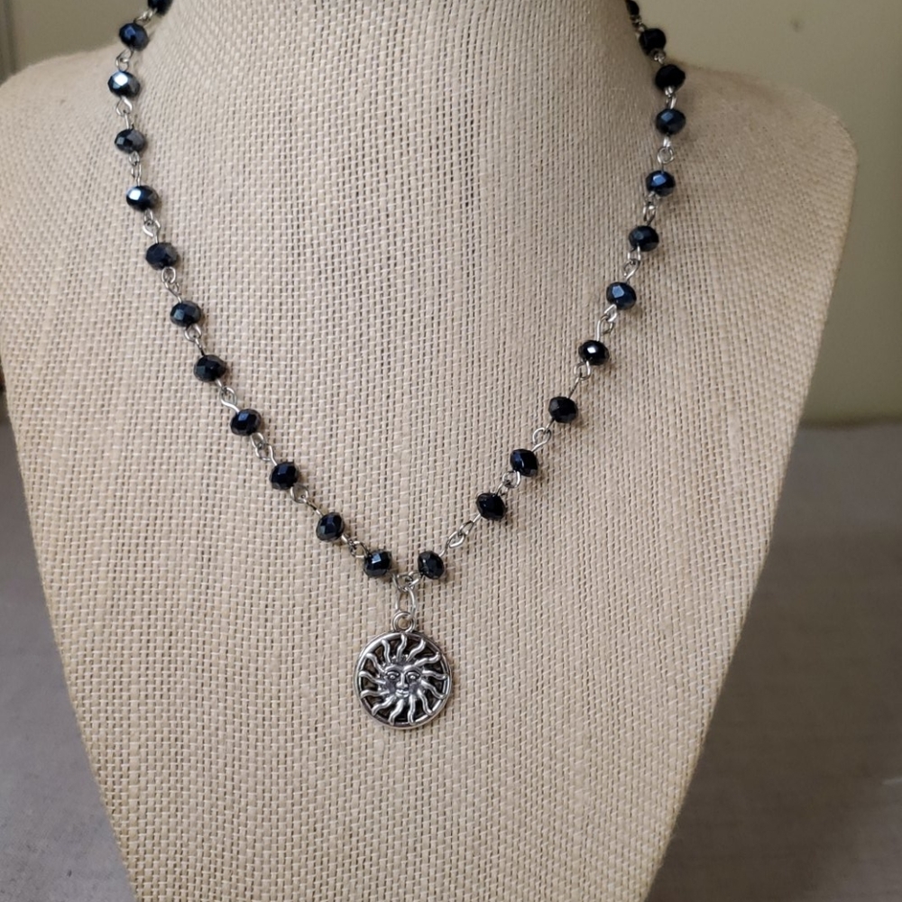 Dark Blue beaded necklace with Sunburst charm.